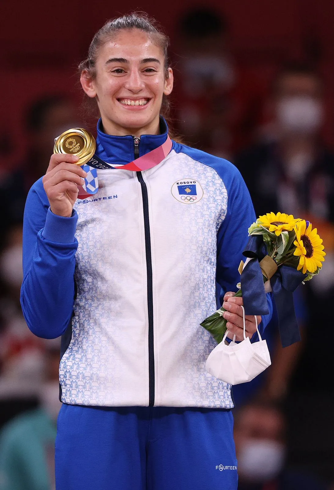 Nora holding Olympic gold medal